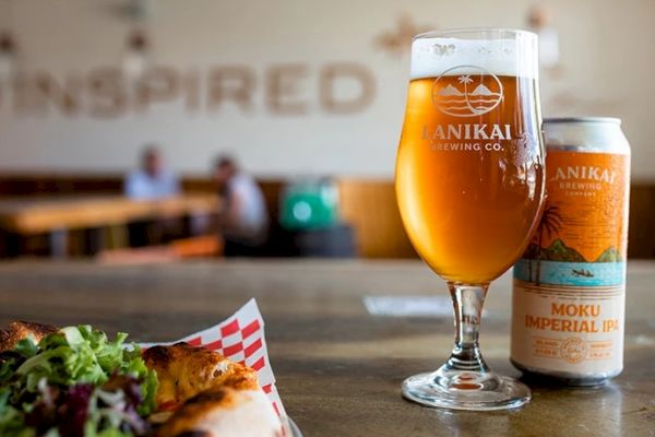 A glass of beer, a can labeled 